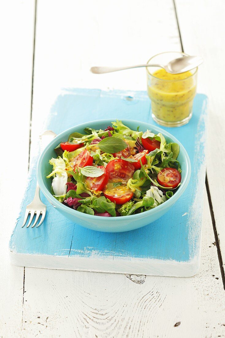 Salad leaves with cherry tomatoes and honey & mustard dressing
