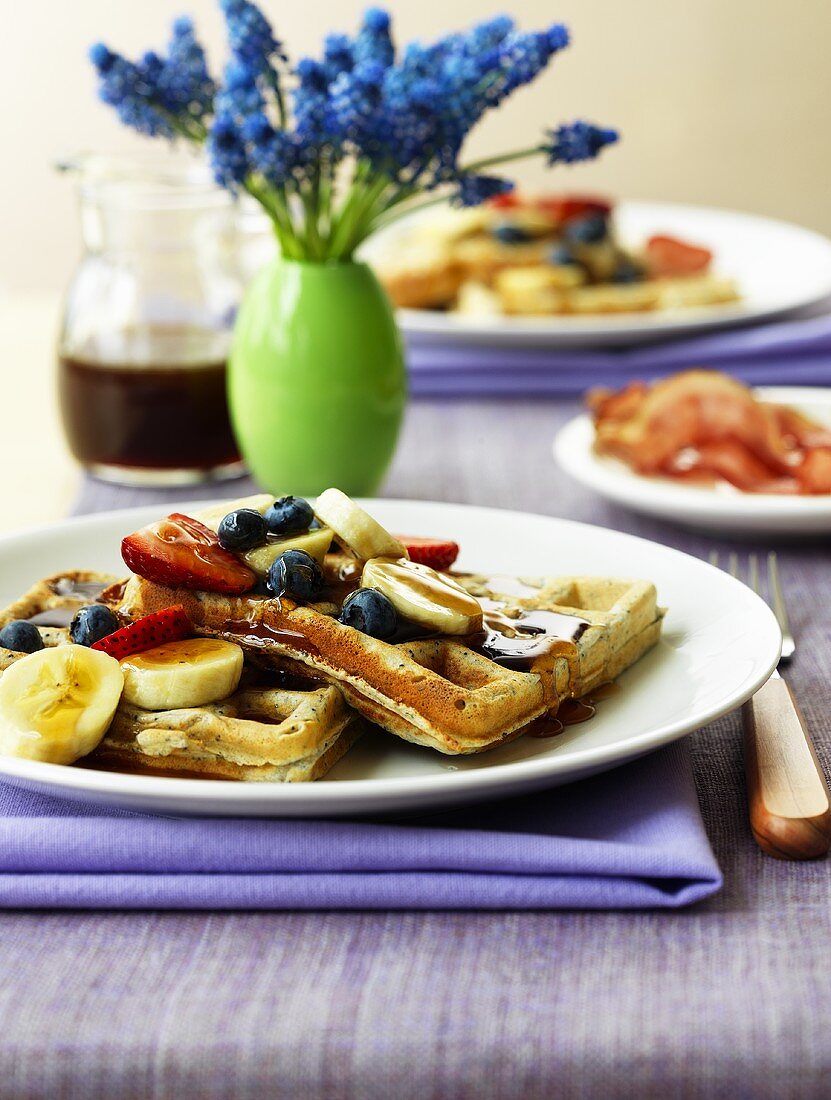 Wholemeal waffles with bananas, berries and maple syrup