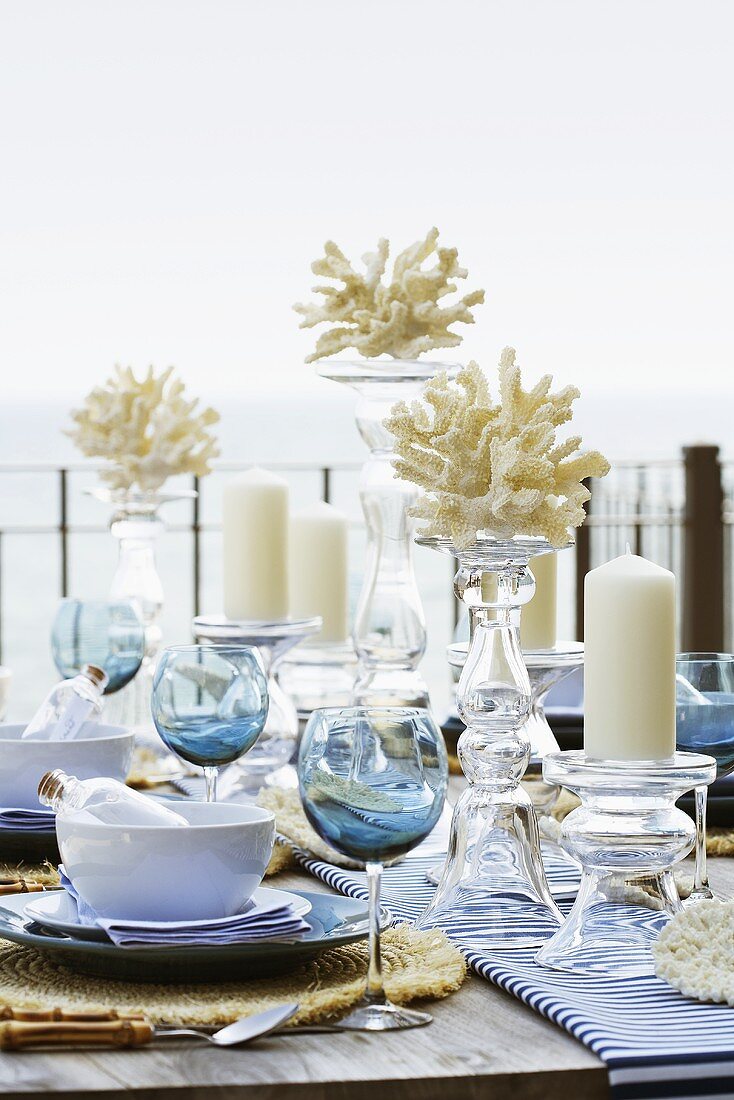 A table laid on a terrace overlooking the sea