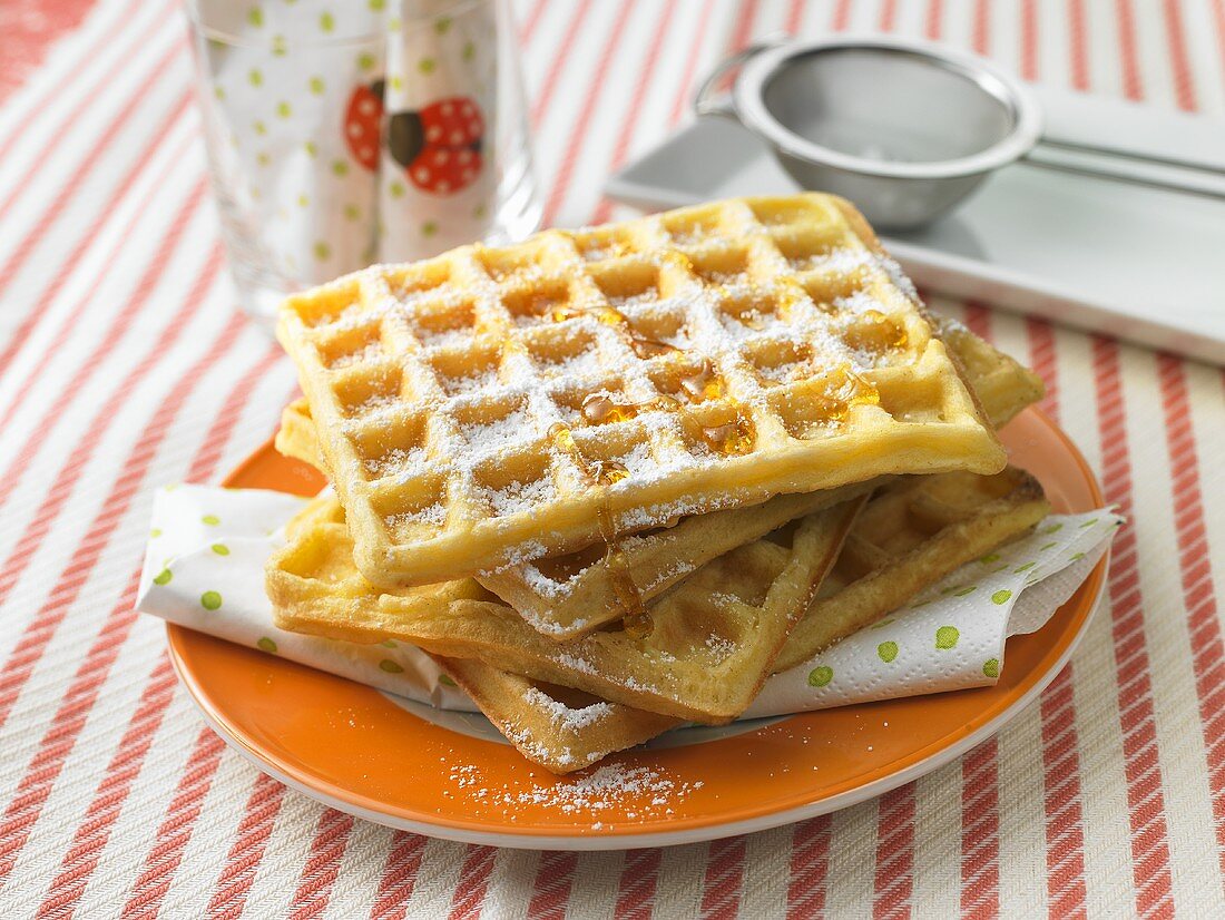 Waffles with syrup and icing sugar