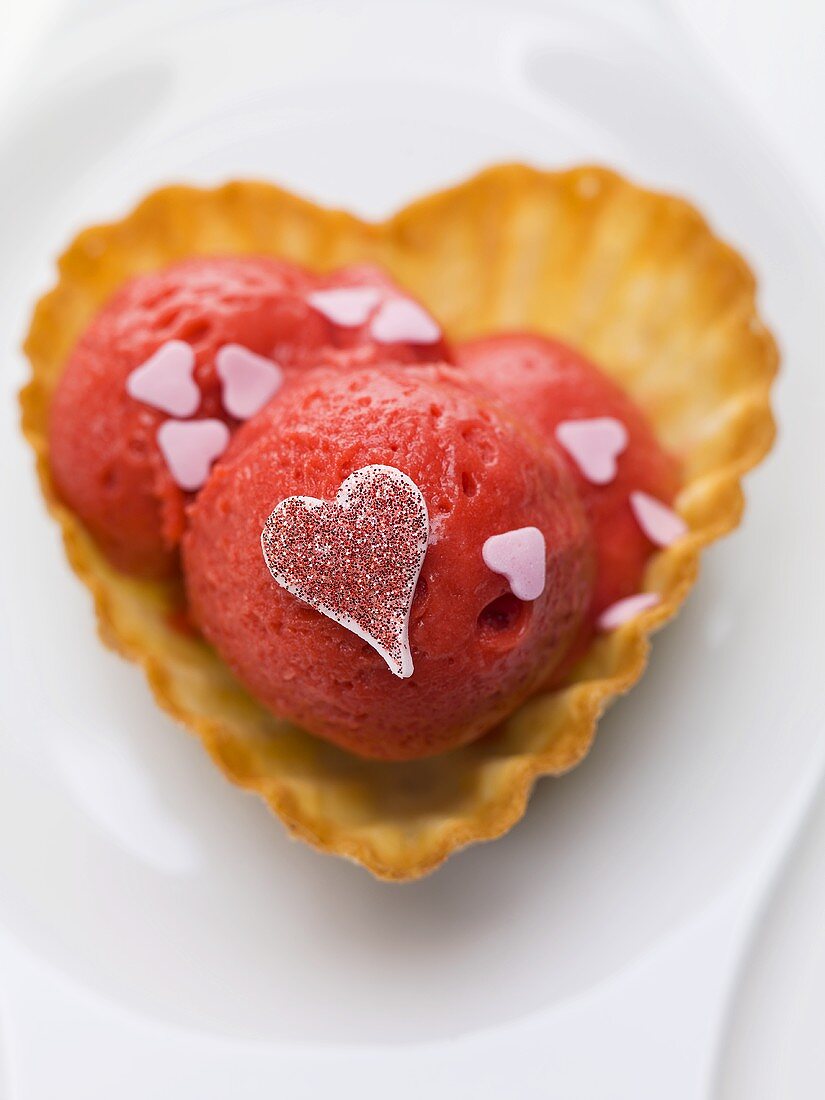 Raspberry ice cream with hearts in wafer bowl