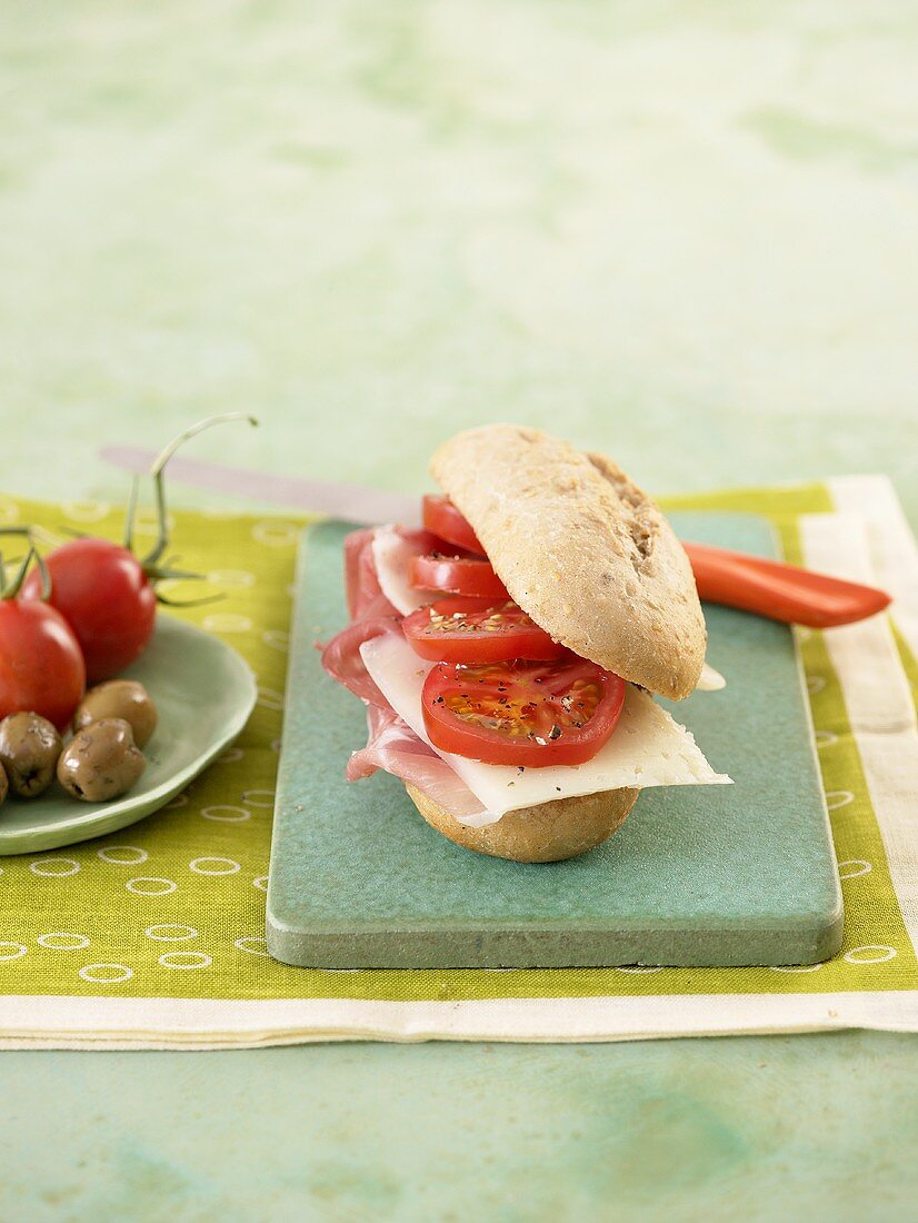 Ham, cheese and tomato in bread roll