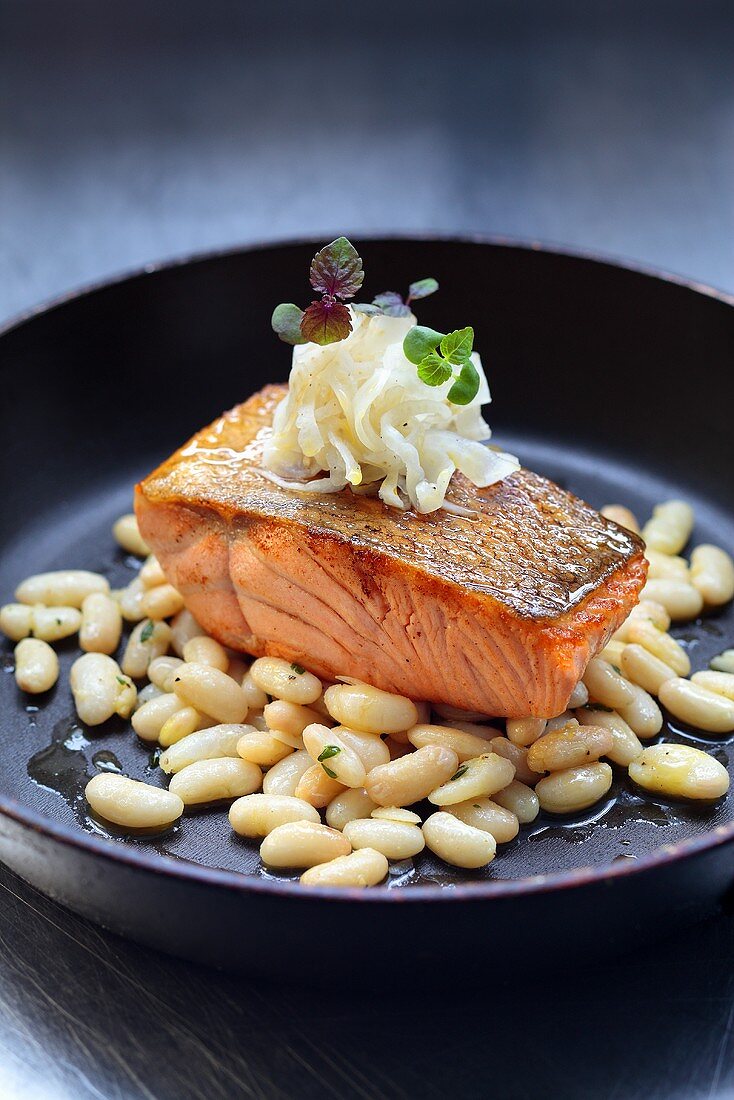 Fried salmon fillet with white beans