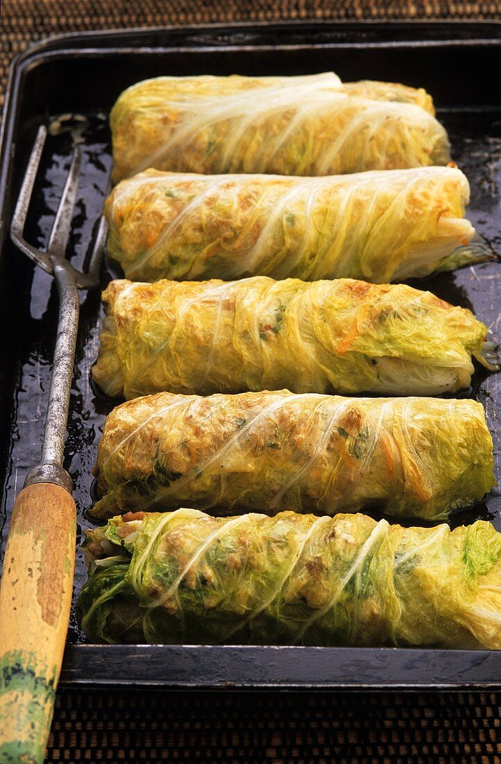 Stuffed cabbage leaves on baking tray