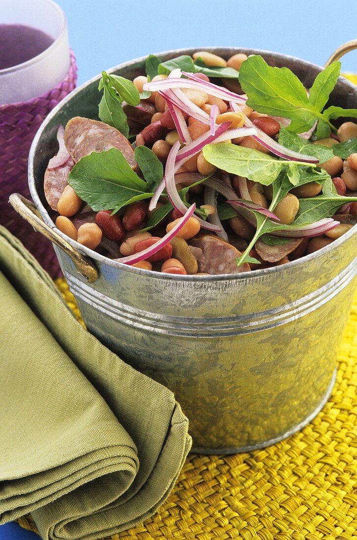 Bean and sausage salad in zinc bucket