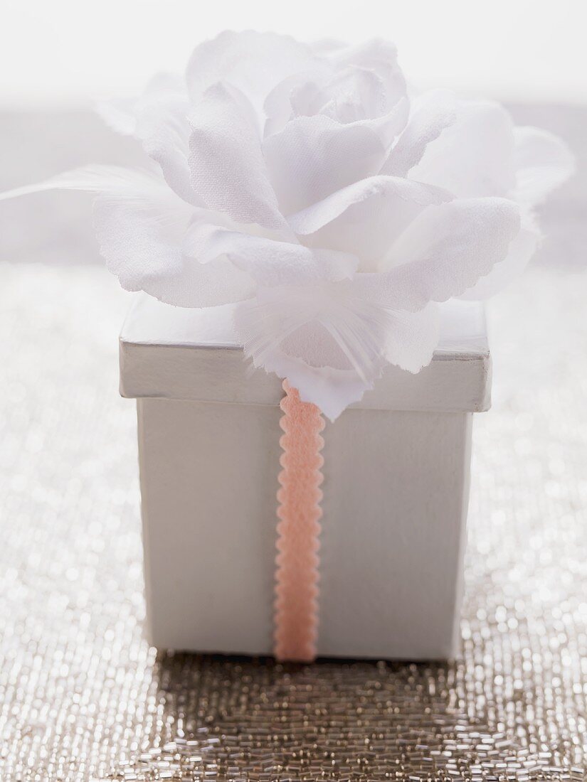 Box with ribbon and white flower