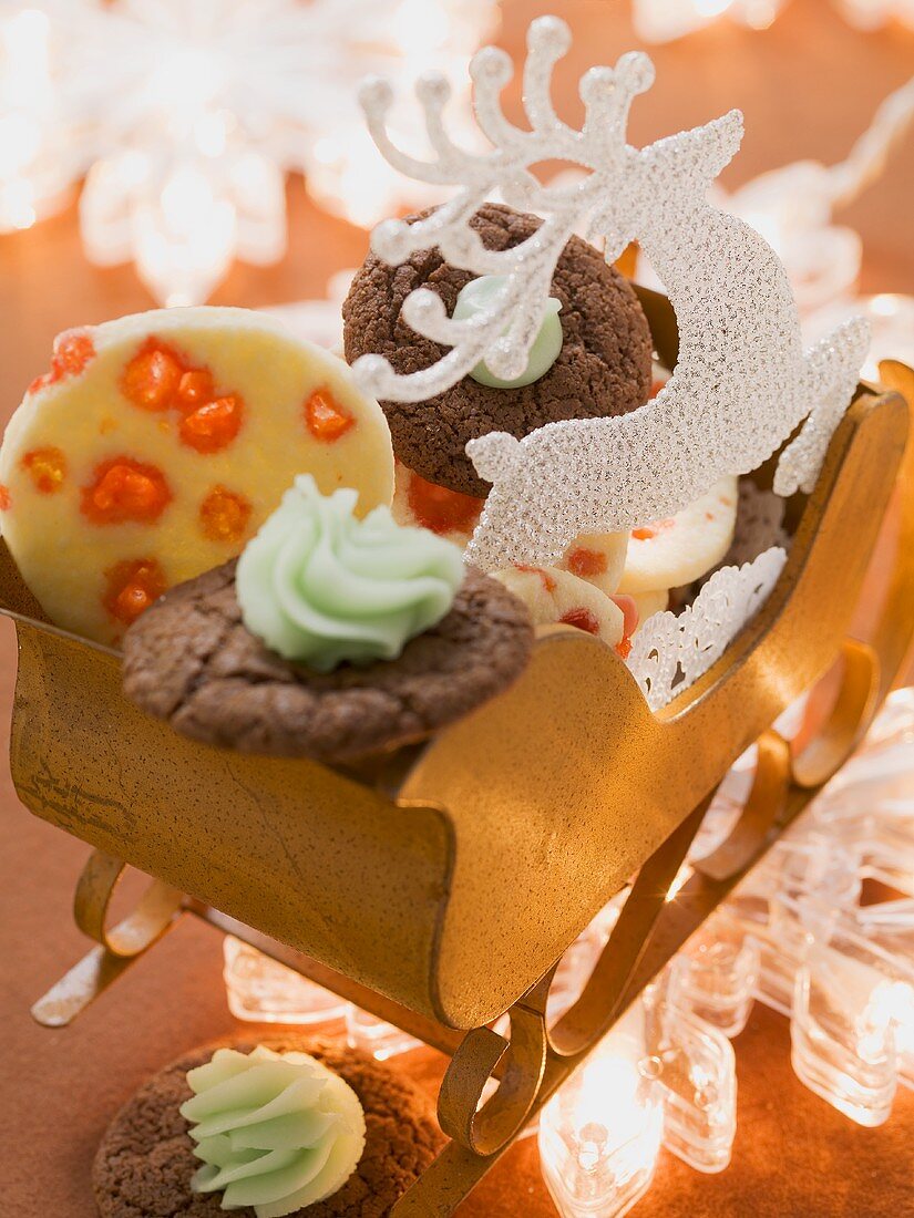 Various types of Christmas biscuits in a small sleigh