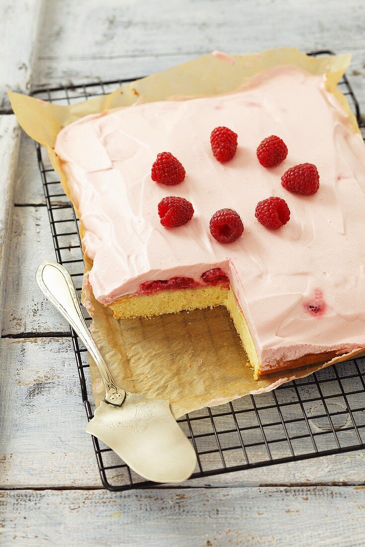 Cake with raspberry mousse topping, a piece removed