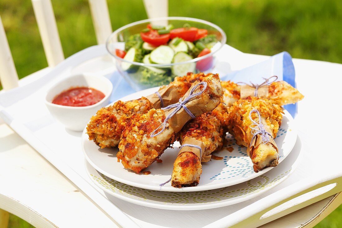 Chicken drumsticks coated in cornflakes and nuts