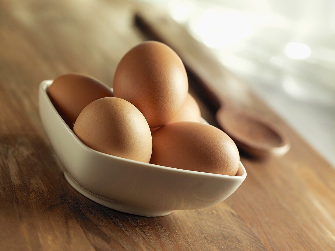 Brown eggs in a white dish