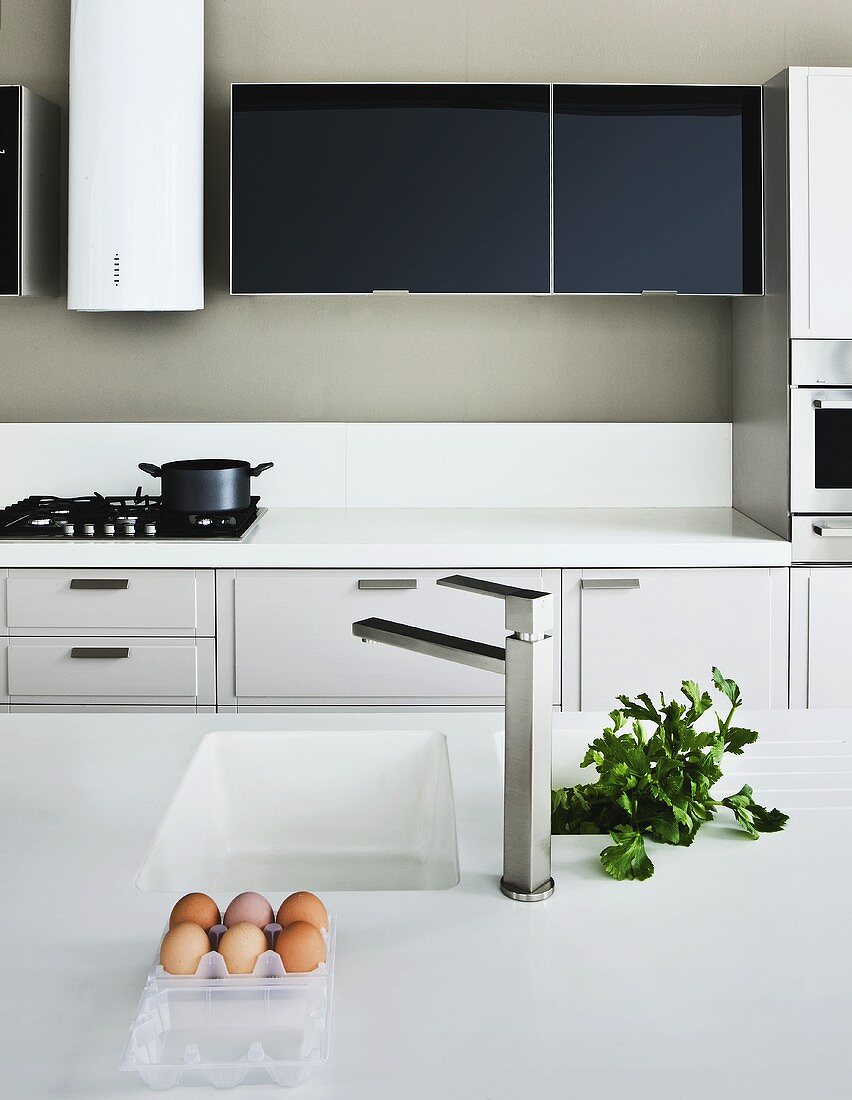 A kitchen with a sink and a gas hob