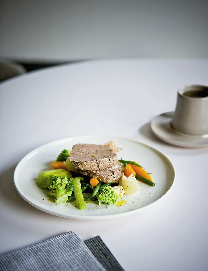 Cooked beef on a bed of vegetables