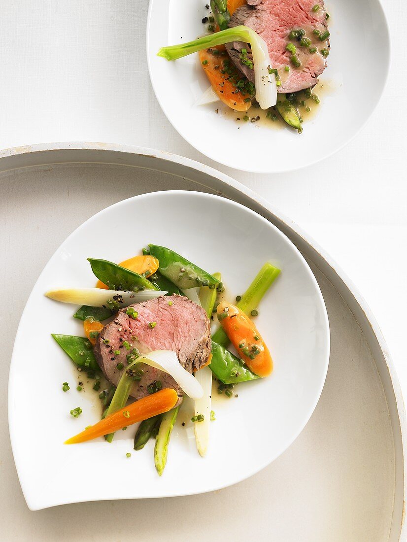 Poached beef fillet on spring vegetables