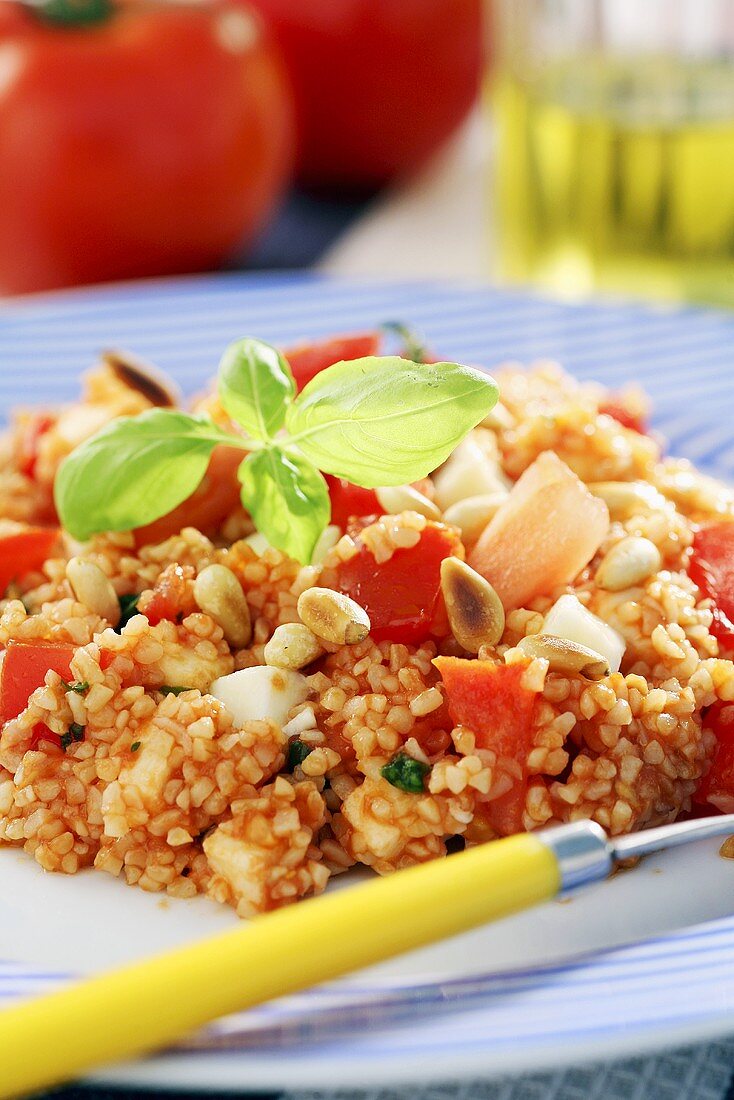 Summery couscous salad with tomatoes and pine nuts