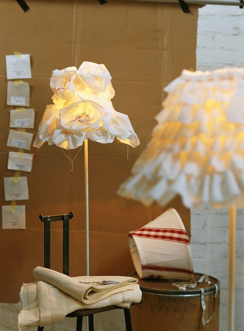 Standard lamps with original lampshades in light designer's workshop