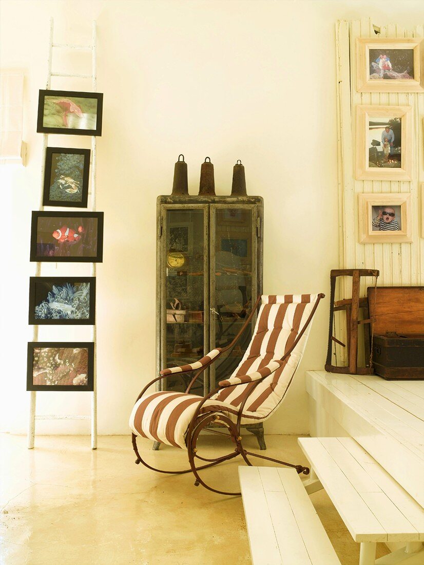 Flea market finds - antique rocking chair with striped upholstery next to white-painted wooden platform