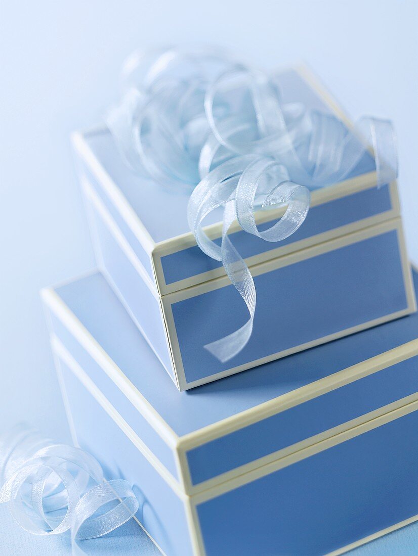 Two blue gift boxes with ribbons