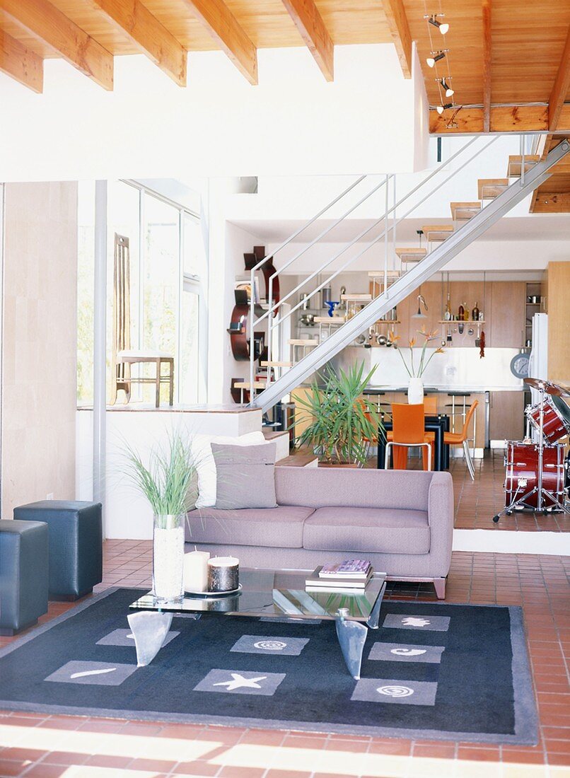 Modern building with open staircase between living area and kitchen-dining room