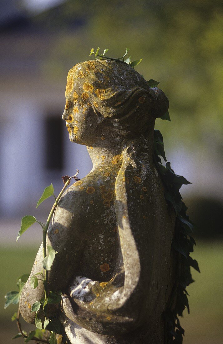 A stone statue in a castle garden