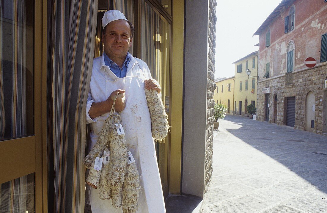 Butcher with home-produced salami, Gaiole, Tuscany