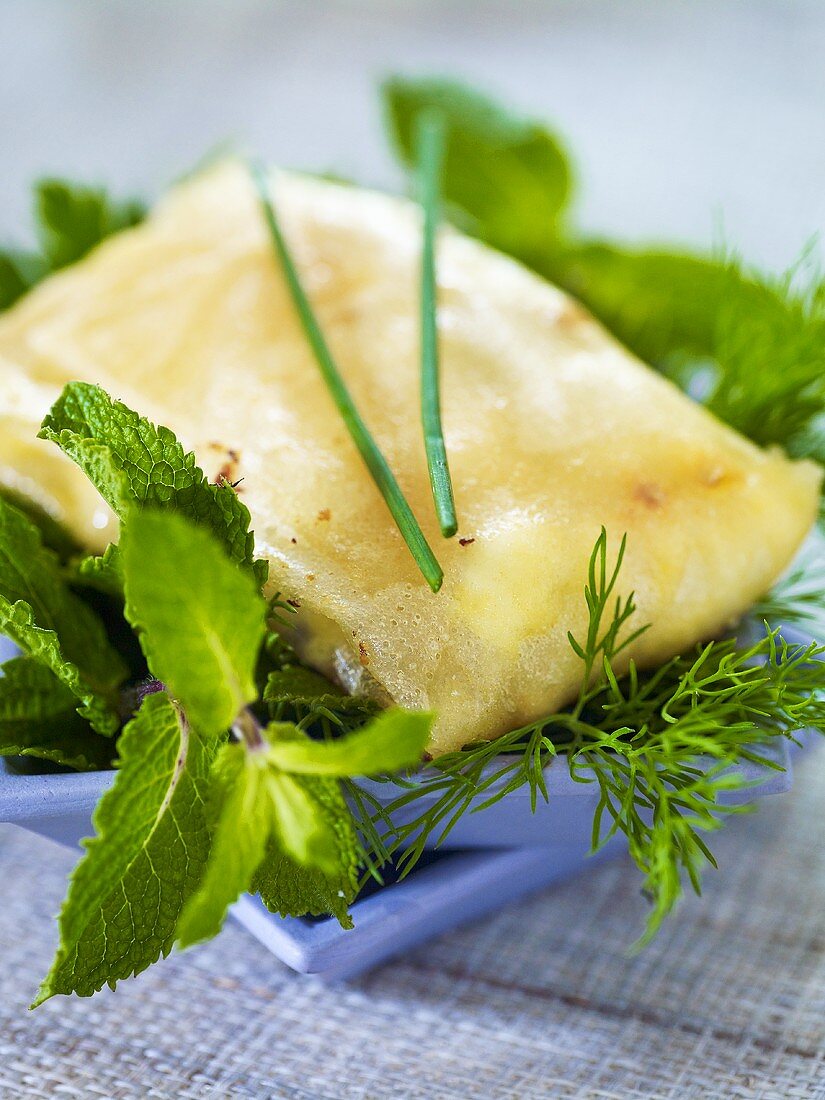 Fried tuna parcels on a bed of fresh herbs