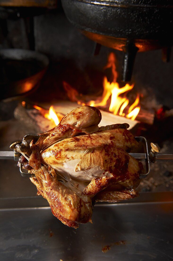 A grilled chicken on a spit