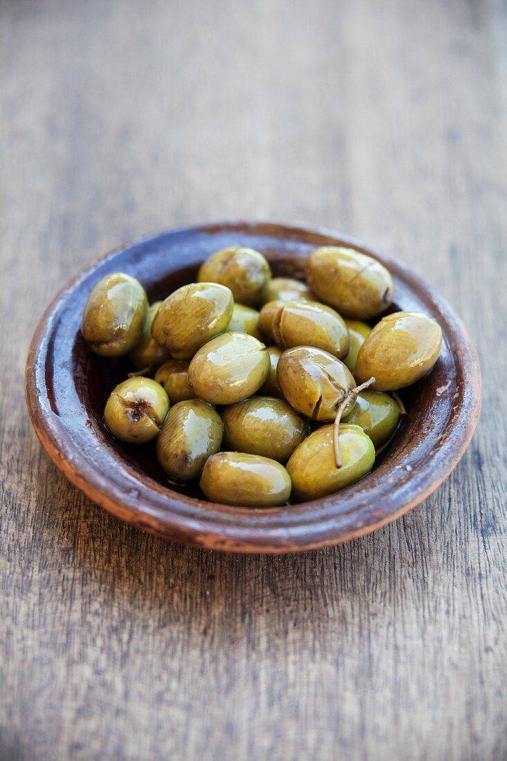 Green olives in a ceramic bowl