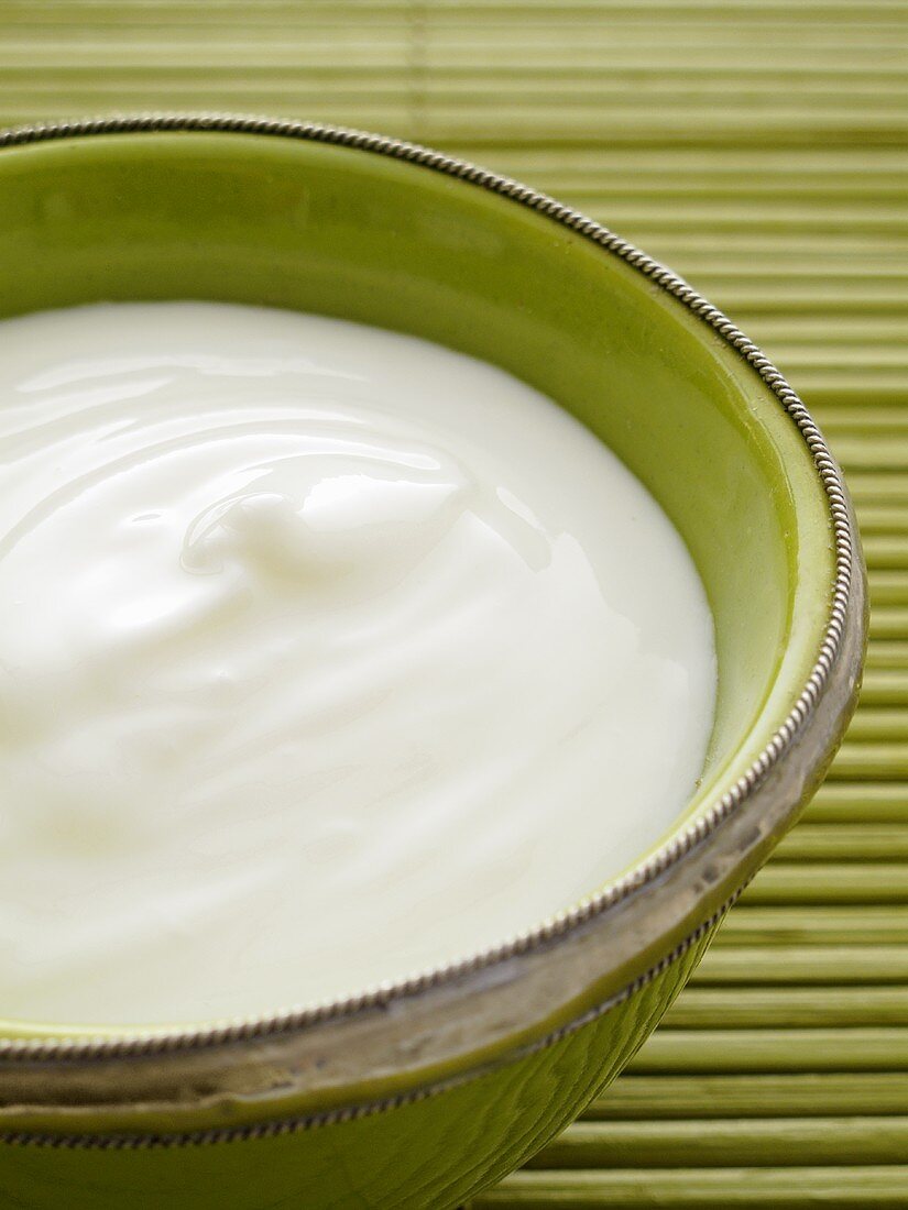 Natural yogurt in a green bowl