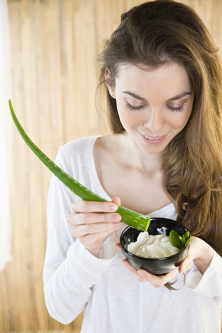 A woman with an aloe vera face mask