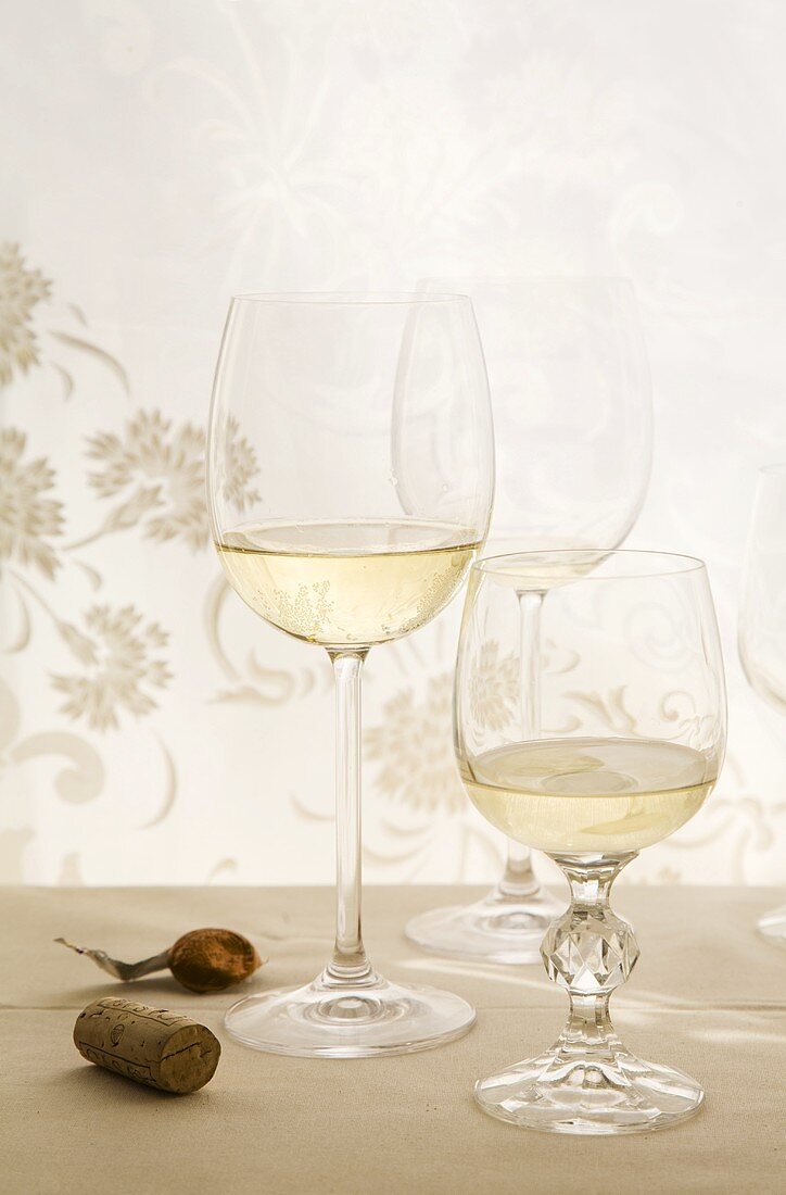 White wine glasses and corks