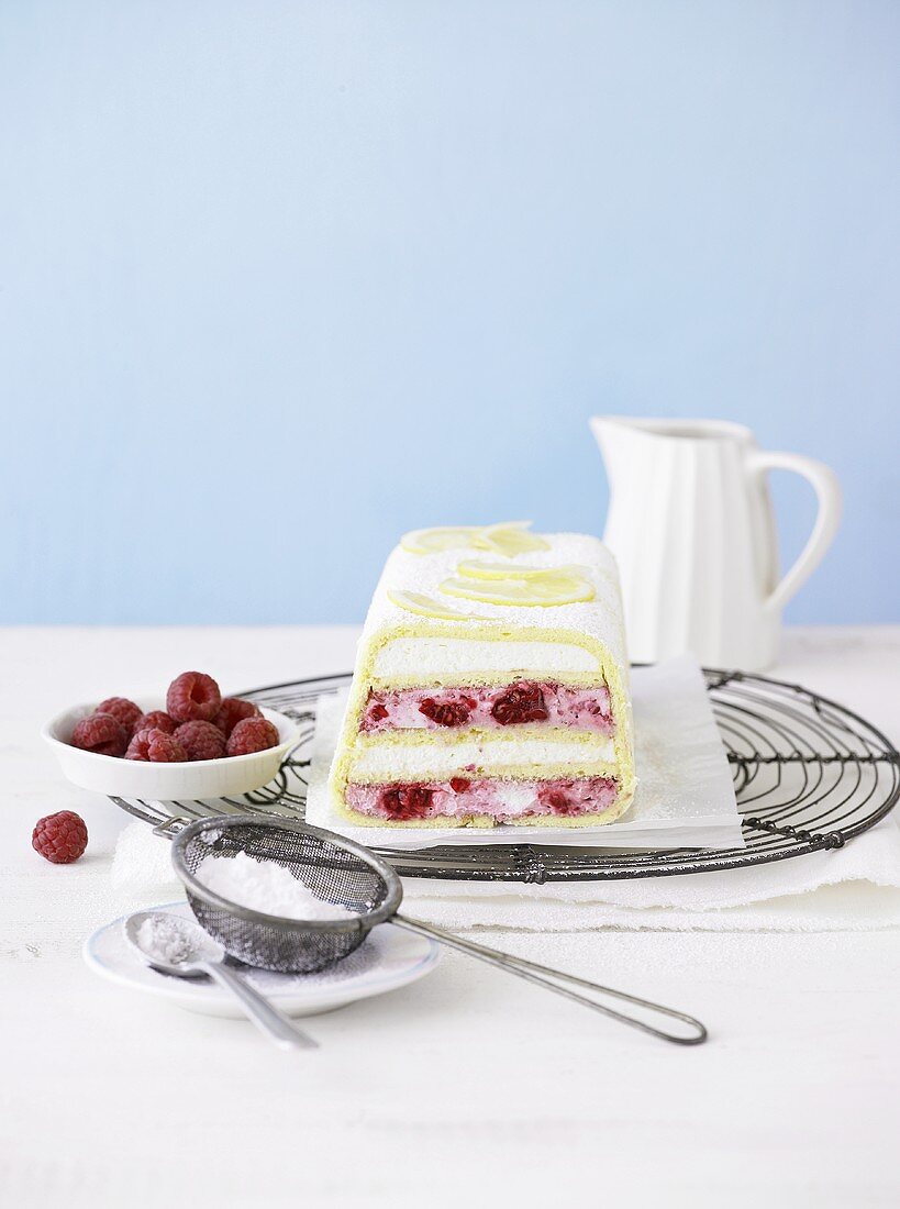 Sliced raspberry and lemon cake on a wire rack