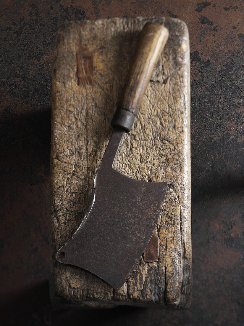 An old meat cleaver on a piece of wood