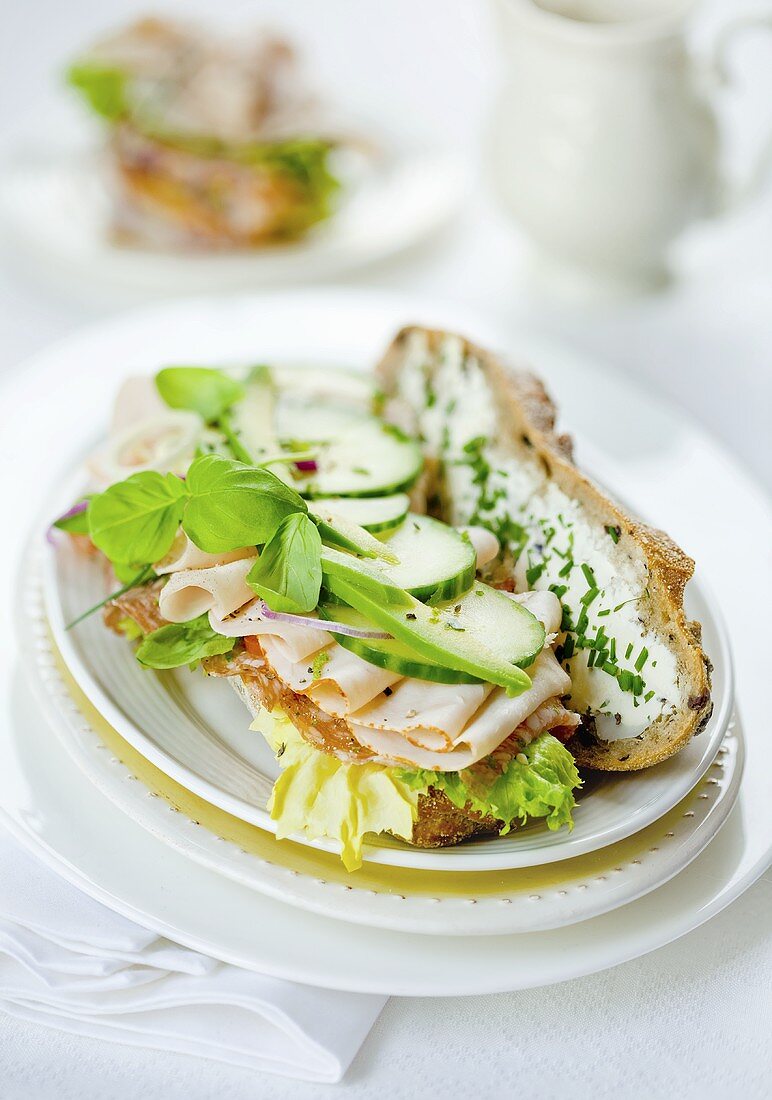 Bread topped with turkey spread, cucumber and lettuce