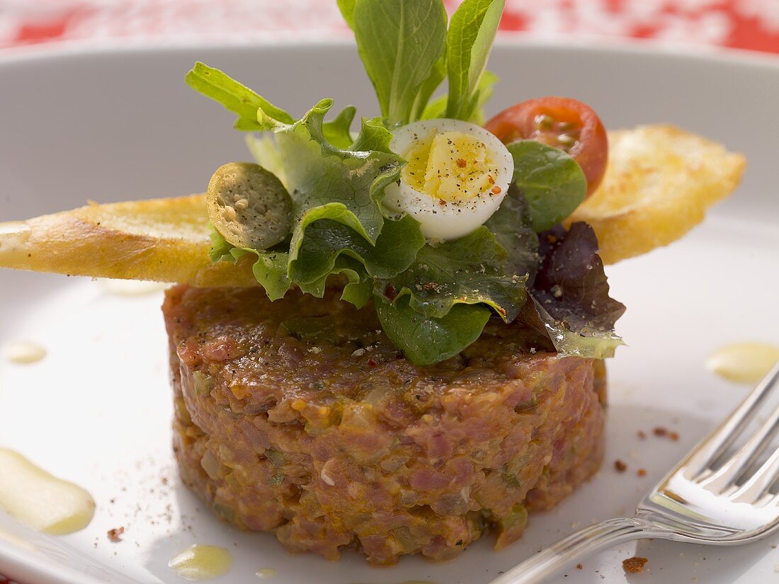Beef tartar with sardines and quail's eggs