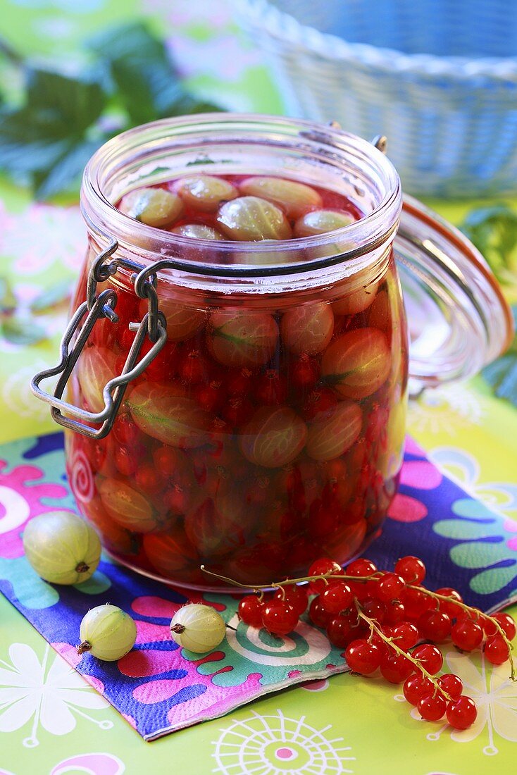 Gooseberry and redcurrant compote in preserving jar