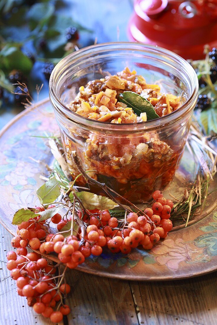 Mushroom sauce in jar with sea buckthorn berries