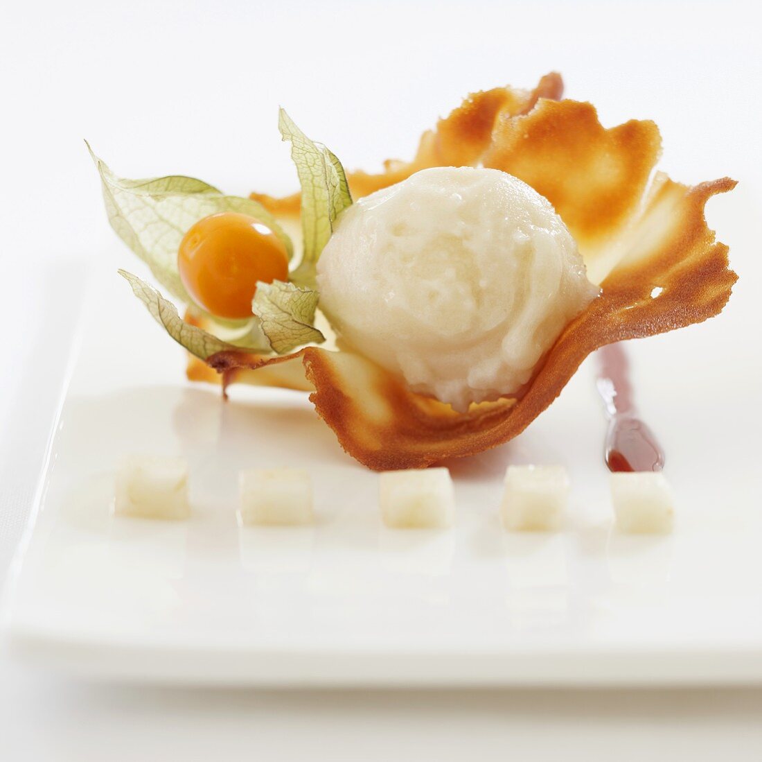 Vanilla ice cream on a wafer with a physalis