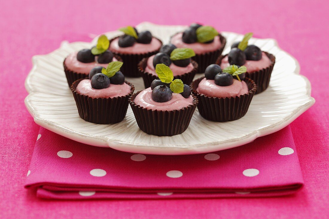 Chocolate bowls with raspberry mousse and blueberries