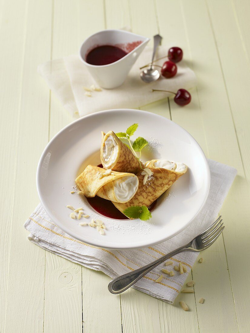 Stuffed crepes with cherry sauce