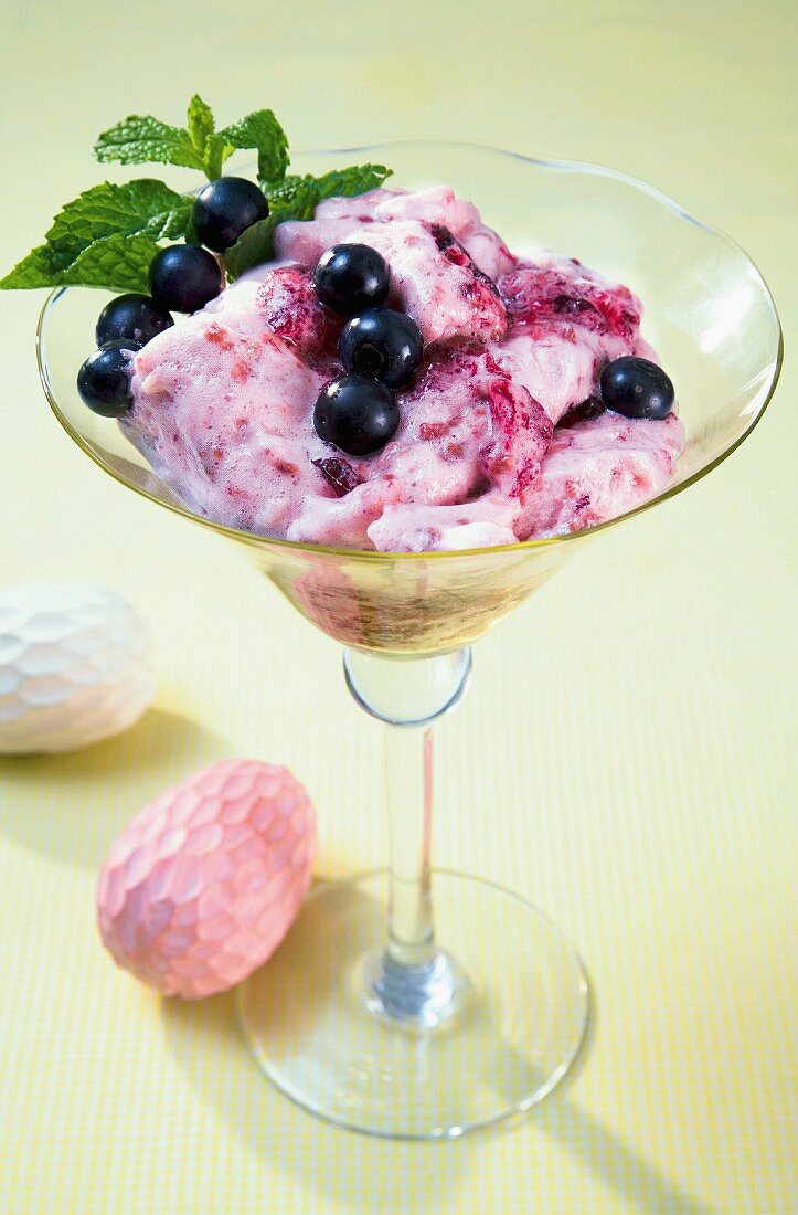 Raspberry mousseline garnished with blackcurrants