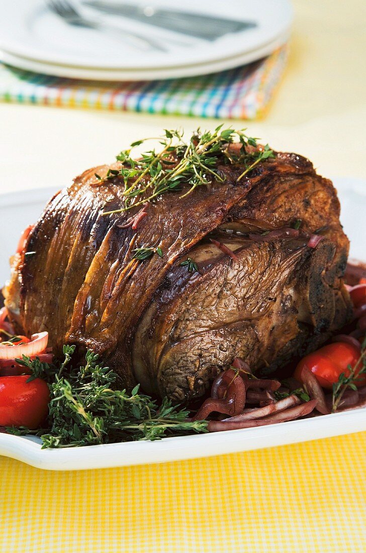 Roast lamb with herbs, onions and peppers