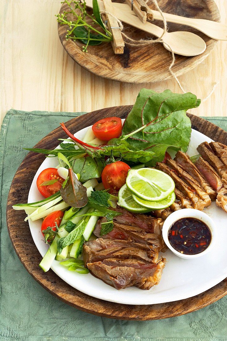 Sliced steak with salad