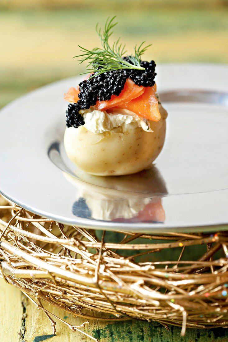 Potato with cream cheese, smoked trout and caviar