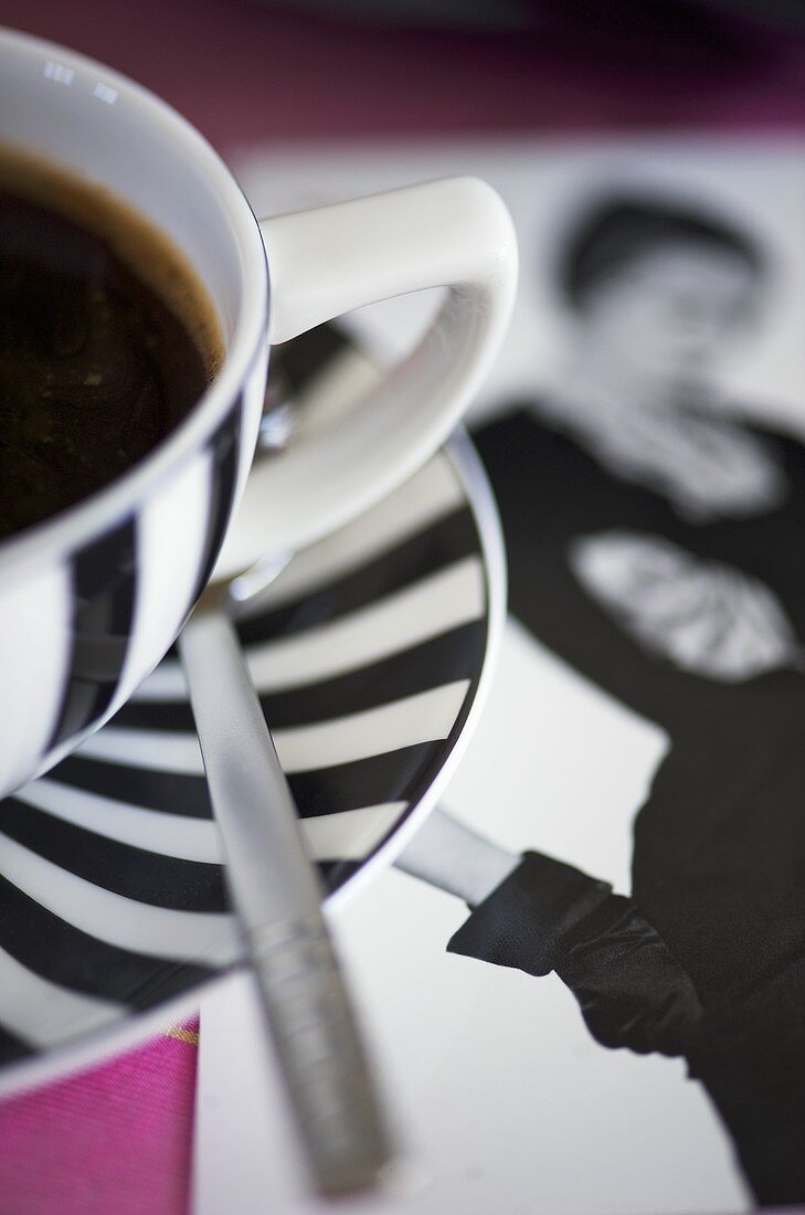 Coffee in striped cup and saucer