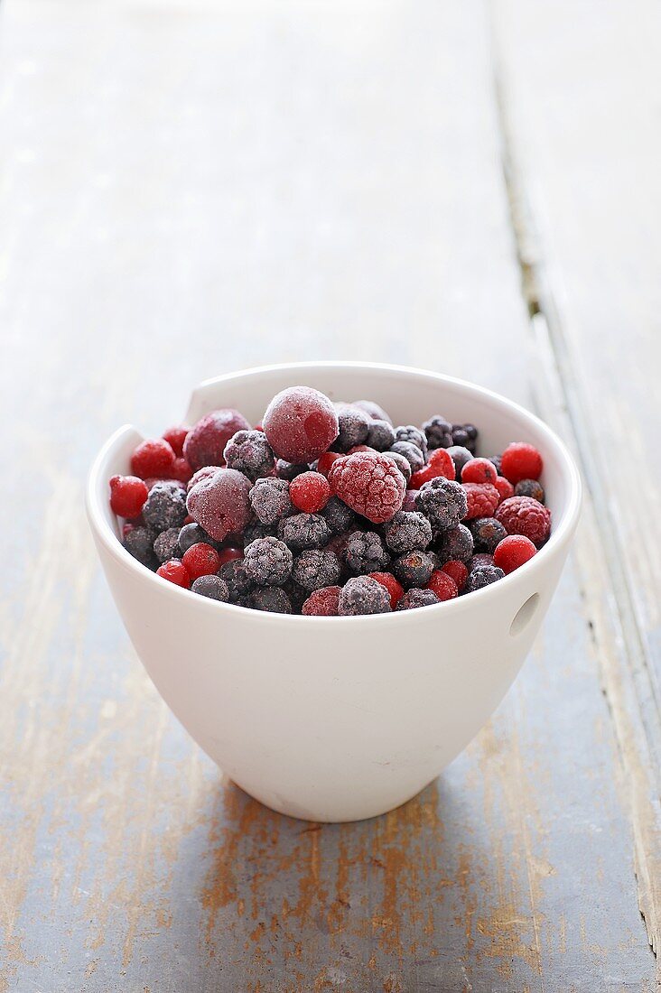 Frozen berries and cherries in basin