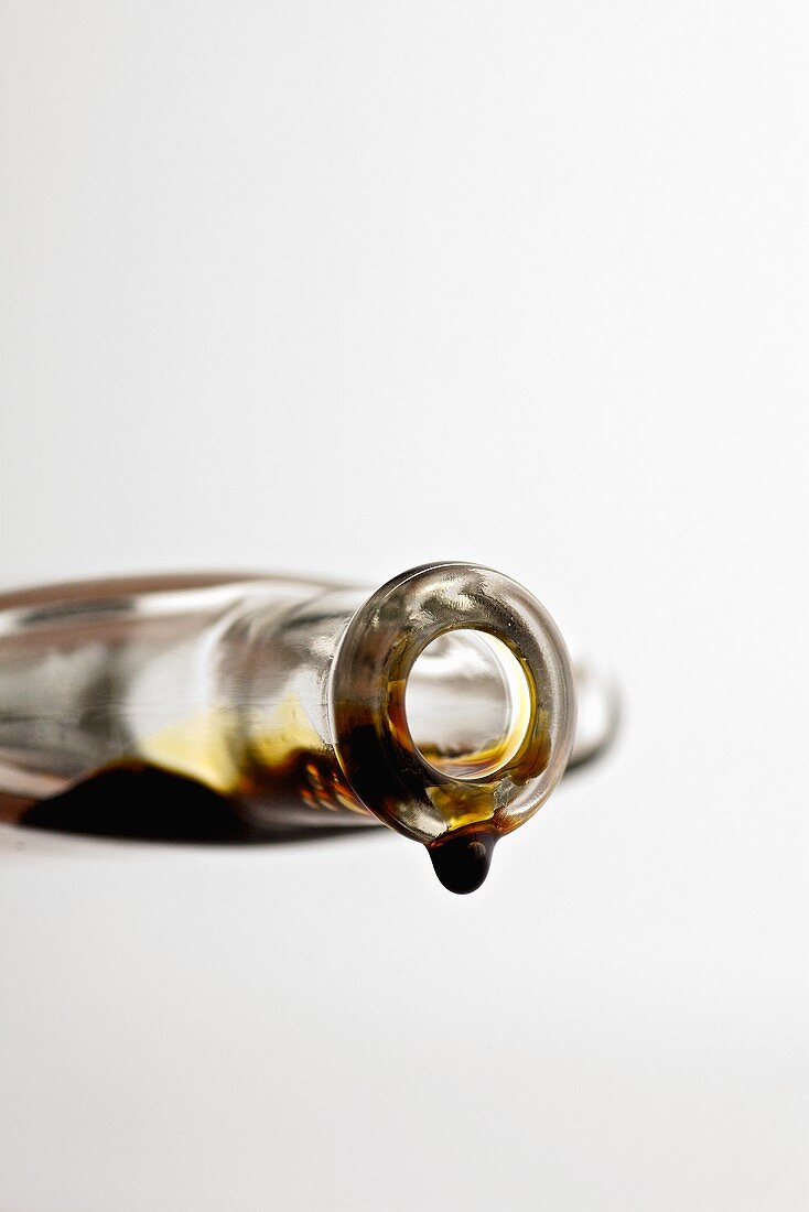 Balsamic vinegar dripping out of glass bottle