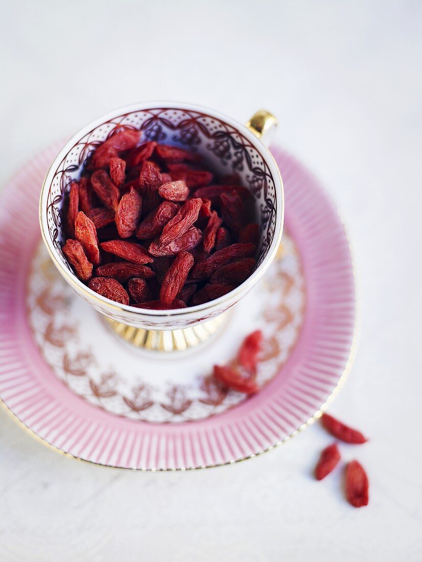 Goji berries in cup and saucer