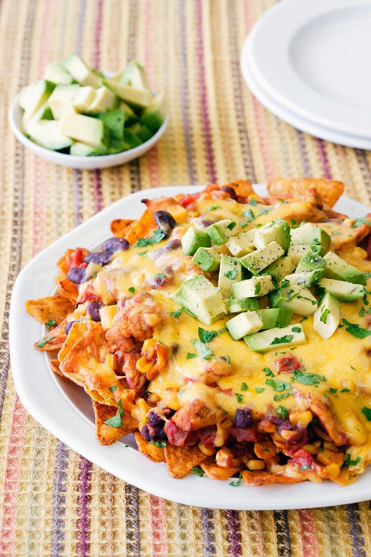 Chicken nachos with melted cheese and avocado