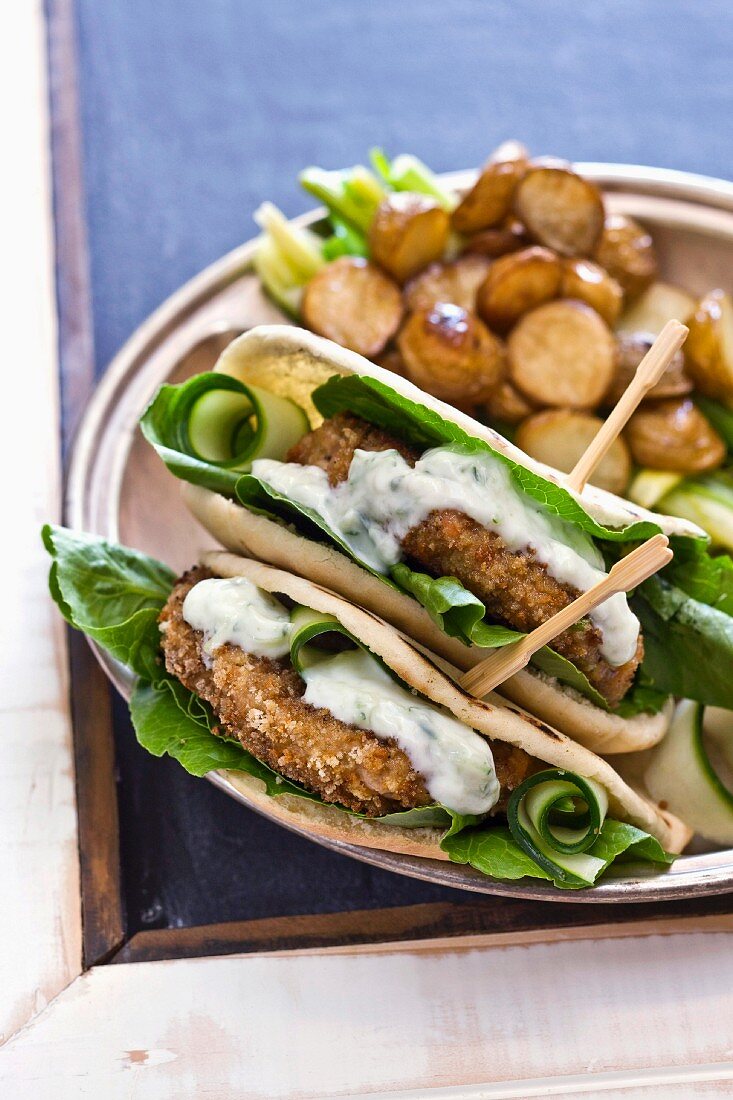 Pita bread filled with fish cakes and tzatziki