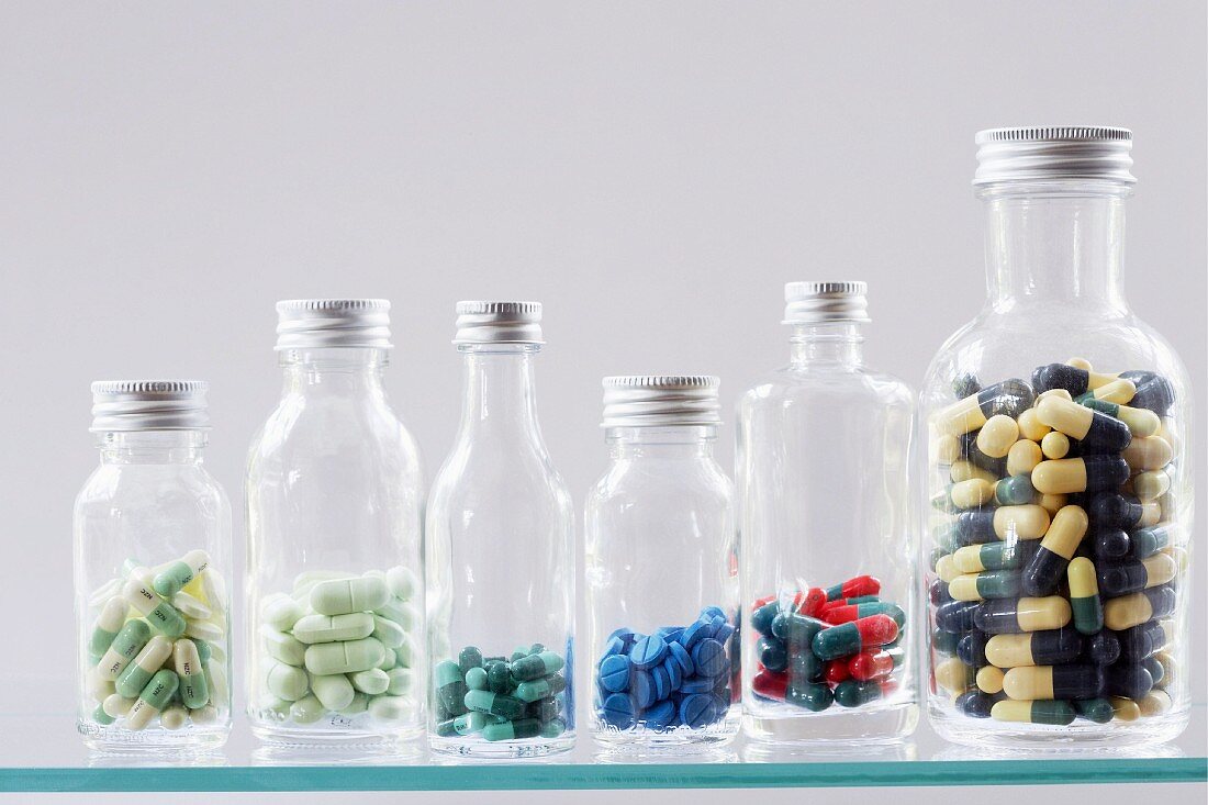 Assorted capsules and tablets in bottles